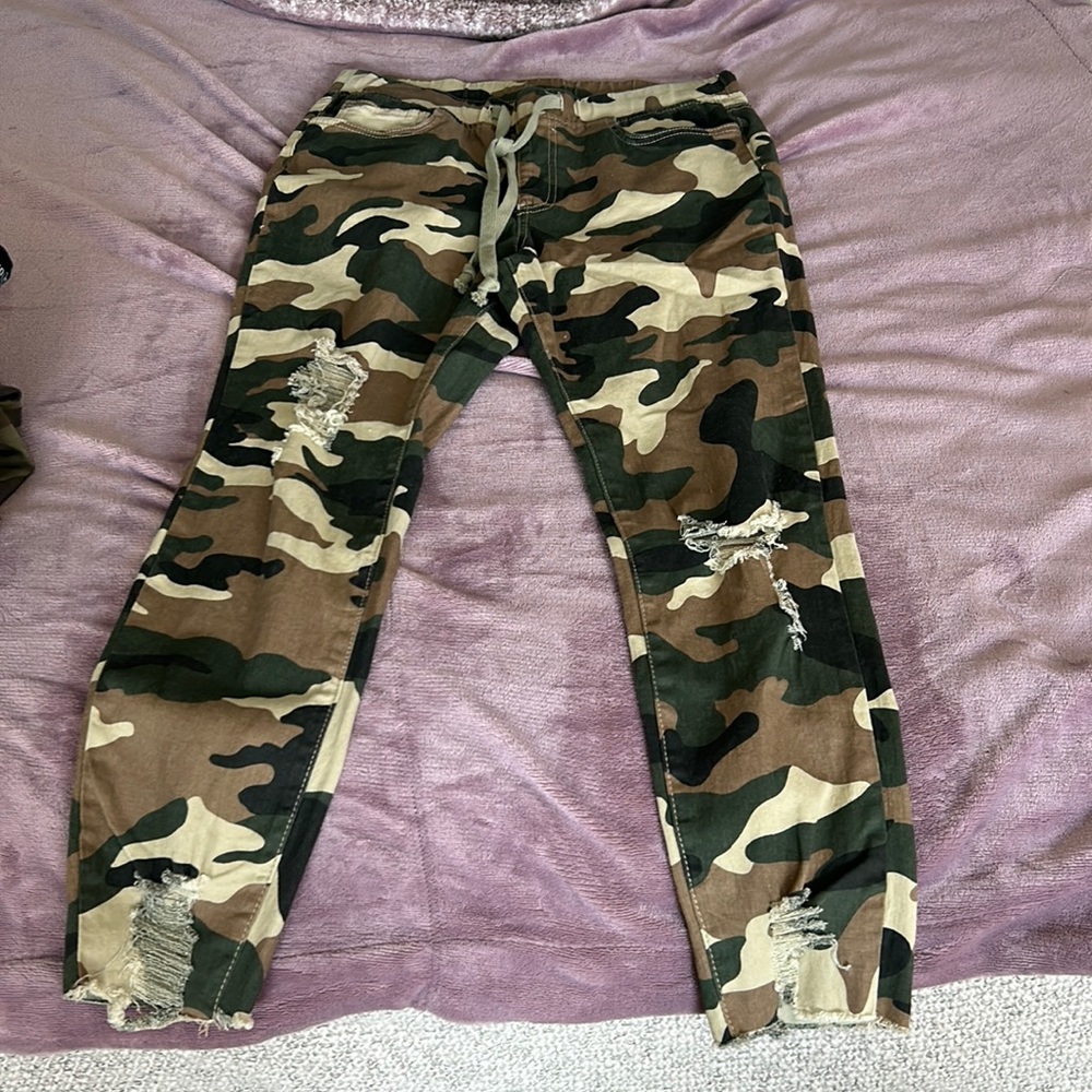 YMI, camouflage pants, rips along with a tie infrount